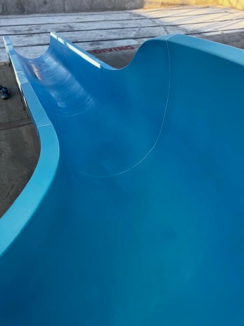Refinished blue slide flume with a smooth high gloss surface