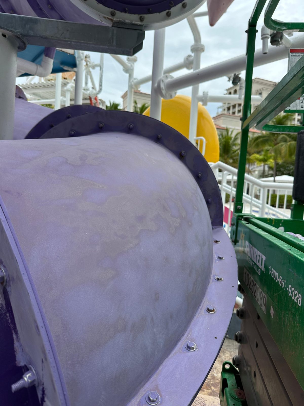 Chalky, faded coating on a purple tube slide before restoration