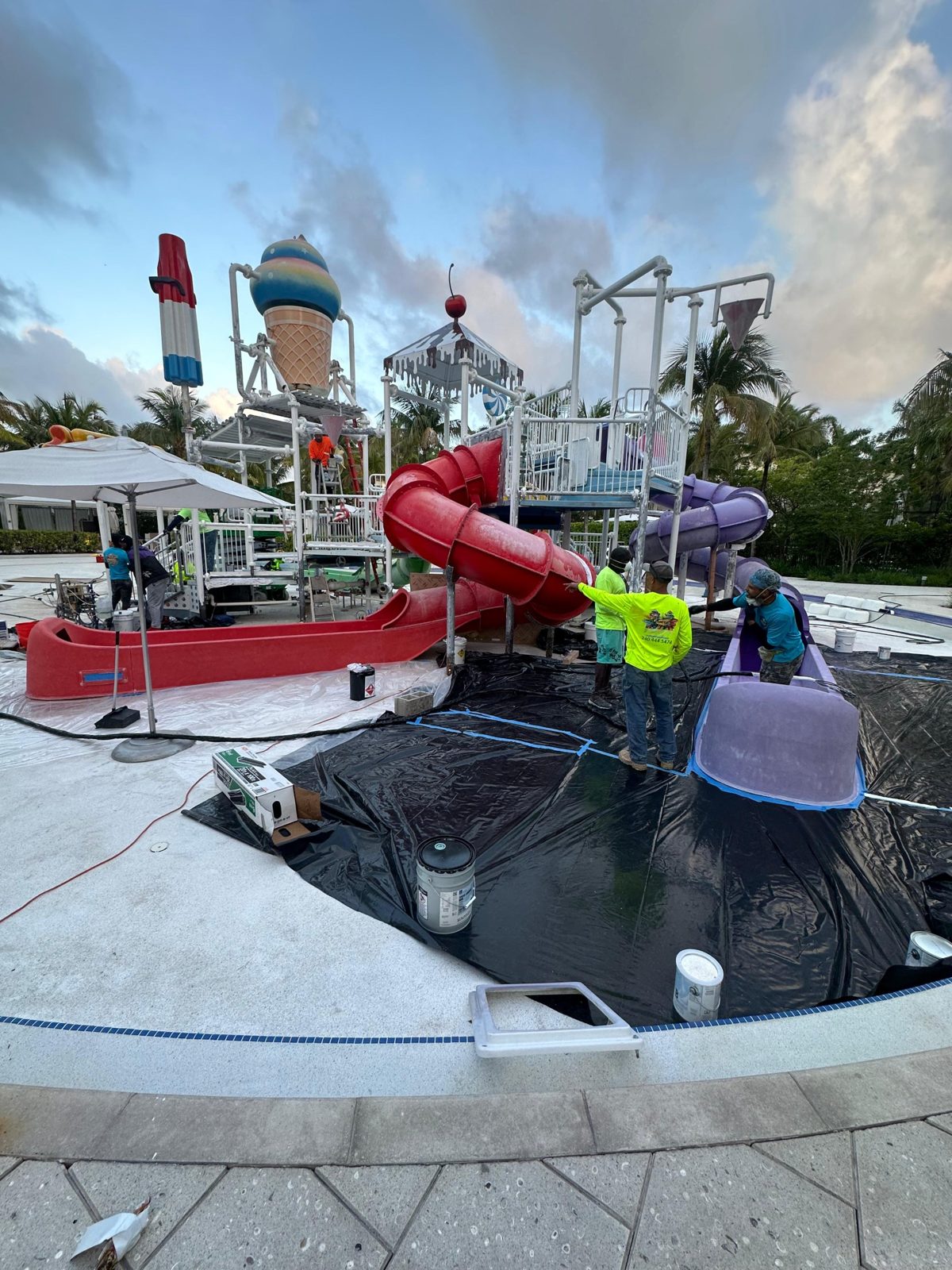 Kids area covered in plastic sheeting while the crew works on the slides