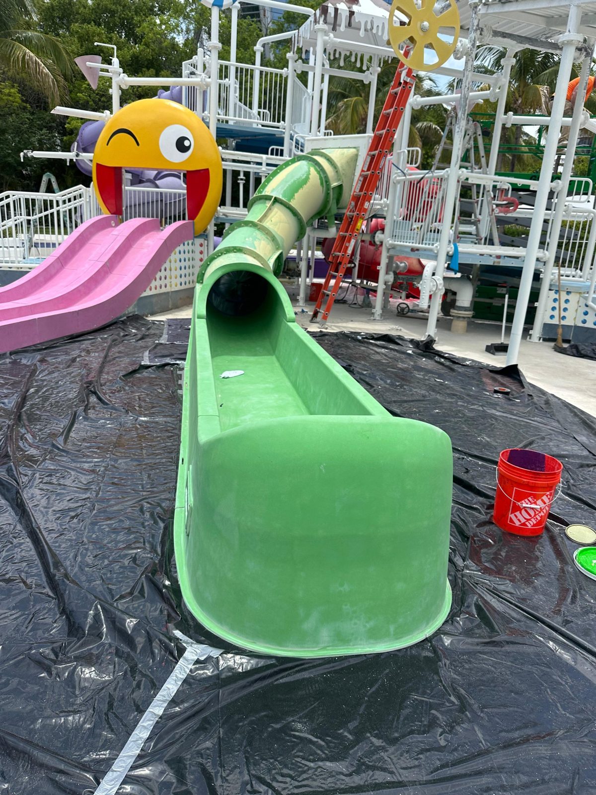 Faded green tube slide and runout before restoration