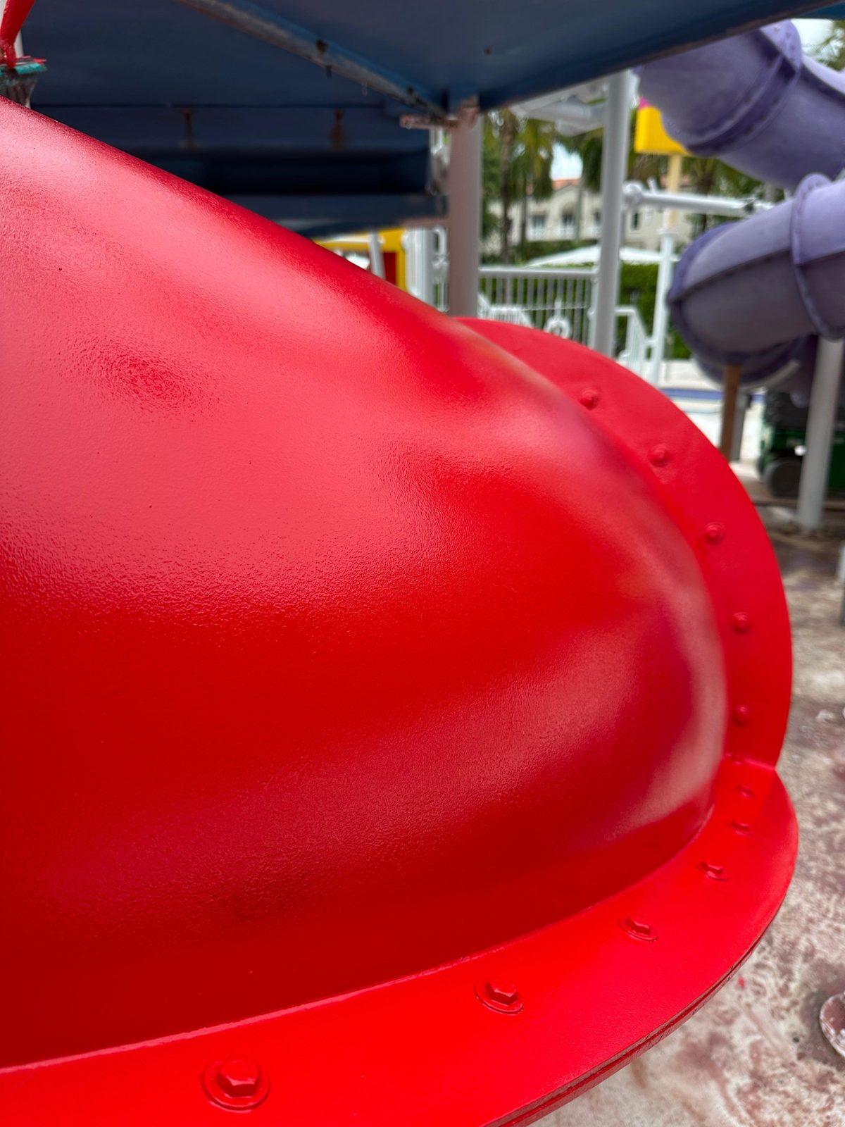 Close view of the fresh red finish on a tube slide