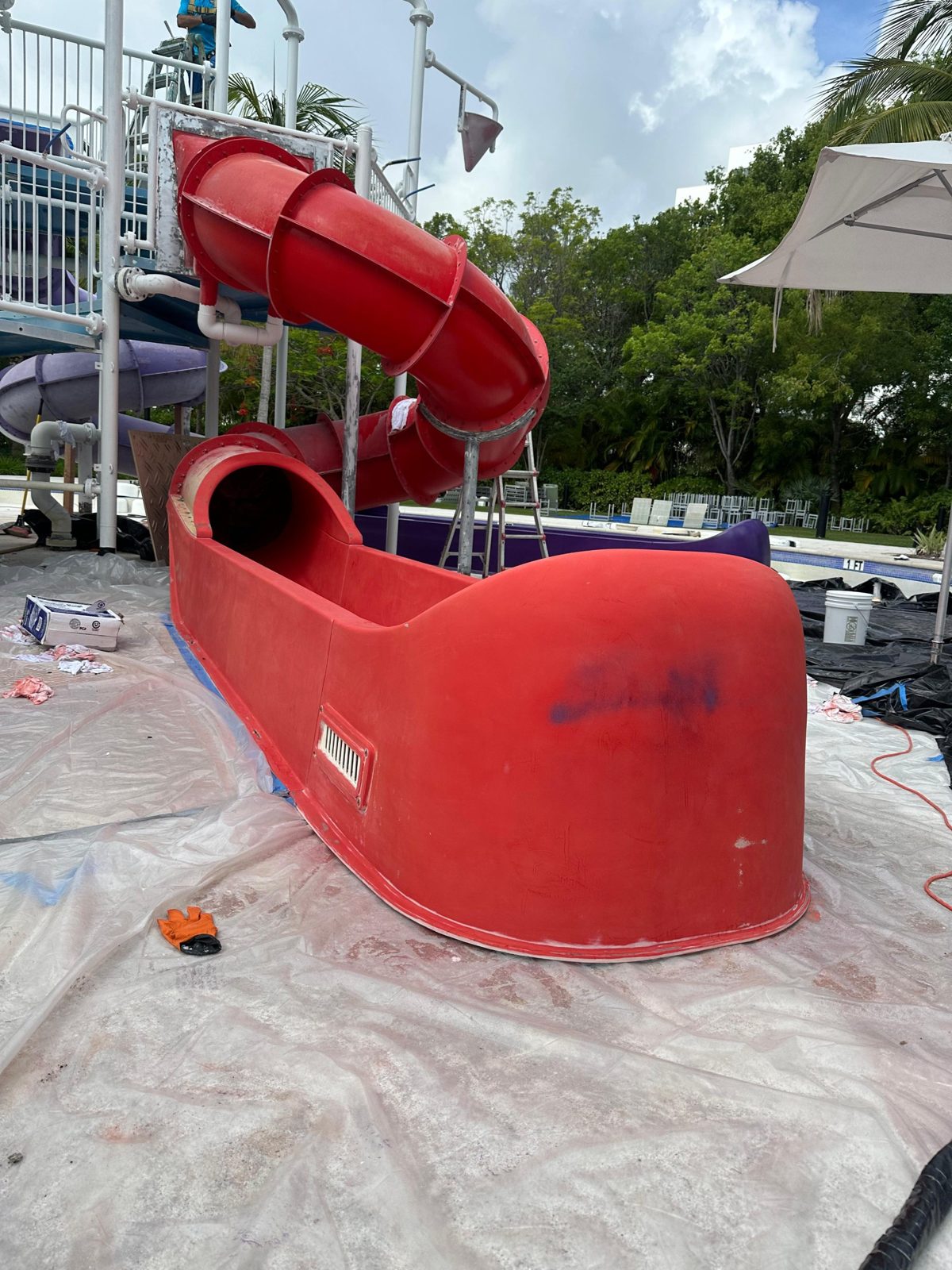 Faded red slide runout with graffiti before restoration