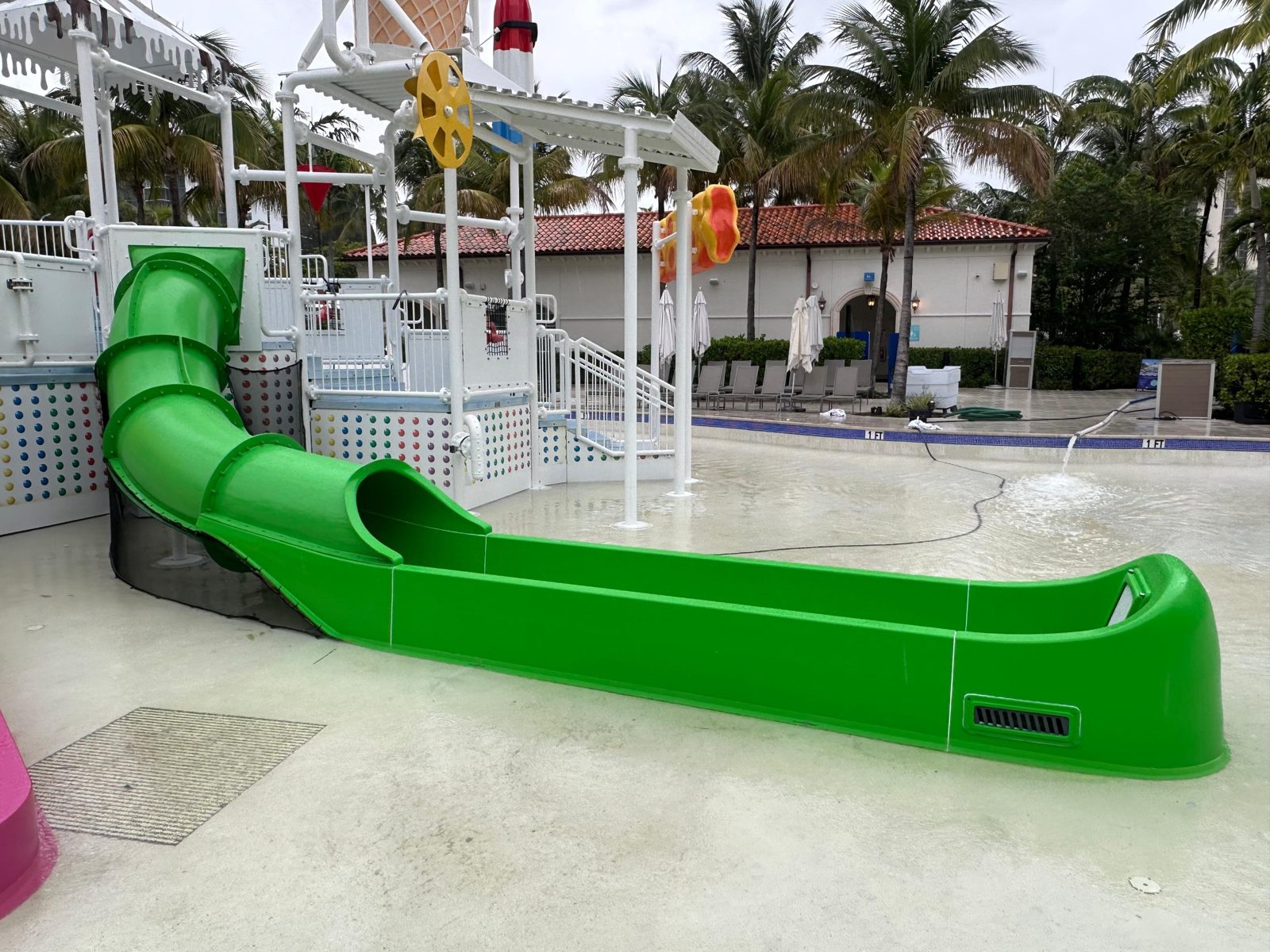 Finished green tube slide and runout in the kids area