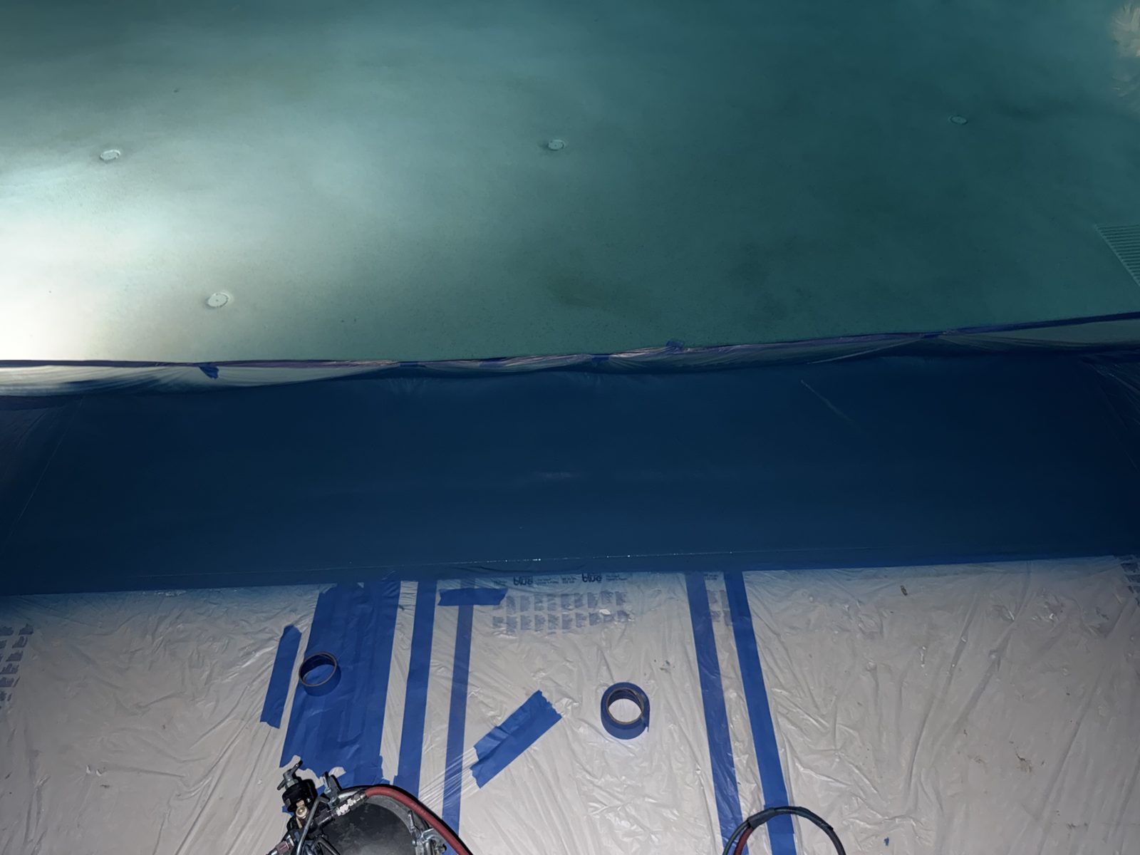Inside an enclosed slide masked off for repairs at night