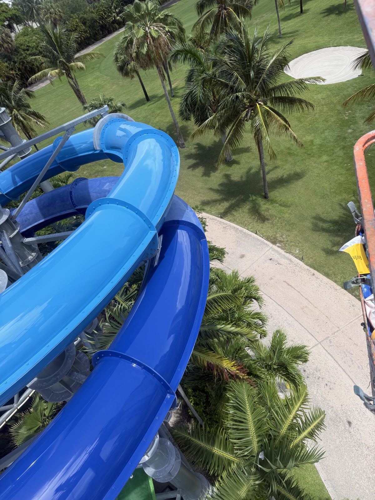 Light blue and dark blue slides looping over the golf course